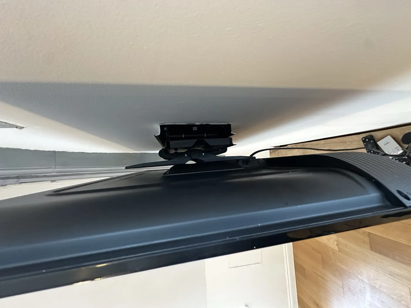 Dust-free wall bracket behind a wall-mounted TV after detail cleaning